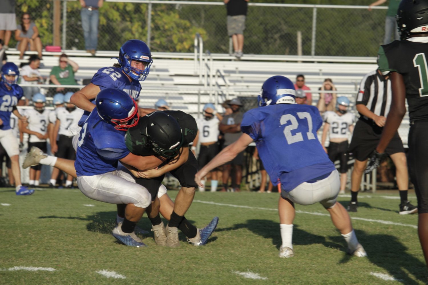 Quitman defenders take down a Quinlan Boles runner in last Friday’s scrimmage.